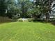Expansive backyard with a well-manicured lawn and a white picket fence providing privacy and charm at 881 Park Manor Nw Ct, Marietta, GA 30064