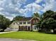 Traditional two-story home featuring a brick and siding exterior, three-car garage, and a well-manicured front lawn at 881 Park Manor Nw Ct, Marietta, GA 30064