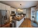 Bright kitchen with stainless steel appliances, a center island with countertop seating, and ample white cabinetry at 881 Park Manor Nw Ct, Marietta, GA 30064