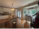 A chef's kitchen with an island, an eating area, and large windows overlooking the backyard at 881 Park Manor Nw Ct, Marietta, GA 30064