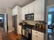 Modern kitchen featuring stainless steel appliances, a gas range, and granite countertops, adjacent to an eat-in area at 881 Park Manor Nw Ct, Marietta, GA 30064