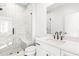 Contemporary bathroom with a glass-enclosed shower, white marble tiling, and black hardware at 490 Hammons Way, Atlanta, GA 30315