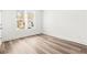 Bedroom featuring light wood flooring and a double window view at 490 Hammons Way, Atlanta, GA 30315