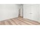Bedroom with light wood floors, double closets, and a white door at 490 Hammons Way, Atlanta, GA 30315