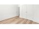 Bedroom with light wood floors, double closets, and a white door at 490 Hammons Way, Atlanta, GA 30315