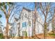 New construction home exterior with white siding, multiple windows, and view of neighborhood homes from a low angle at 490 Hammons Way, Atlanta, GA 30315