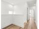 Hallway with light hardwood floors and white walls leads to multiple rooms at 490 Hammons Way, Atlanta, GA 30315