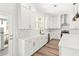 Kitchen with white cabinets, stylish backsplash, and stainless steel appliances at 490 Hammons Way, Atlanta, GA 30315