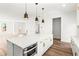 Modern white kitchen with island and stainless steel appliances at 490 Hammons Way, Atlanta, GA 30315