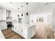 Open-concept kitchen and living room with island and stainless steel appliances at 490 Hammons Way, Atlanta, GA 30315