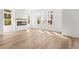 Bright living room with light wood floors, a decorative fireplace, and large windows at 490 Hammons Way, Atlanta, GA 30315