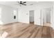 Spacious primary bedroom featuring hardwood floors, ceiling fan, and walk-in closet at 490 Hammons Way, Atlanta, GA 30315