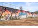 Mural of Chosenwood Park features a colorful depiction of children playing, trees, and the name of the park at 490 Hammons Way, Atlanta, GA 30315
