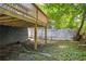 A partial view of the backyard showing the supports of the deck and a white fence at 85 Ollie St, Atlanta, GA 30314
