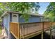 A view of the backyard and blue house with a wooden deck and a white door at 85 Ollie St, Atlanta, GA 30314