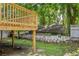 A view of the backyard with a deck and an old wooden building near a cinder block wall at 85 Ollie St, Atlanta, GA 30314