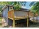 A view of the backyard with a deck on a blue home. The deck has wooden railings at 85 Ollie St, Atlanta, GA 30314