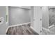 Bathroom features wood-look floors, gray walls, and a shower with marble-look tile at 85 Ollie St, Atlanta, GA 30314