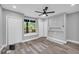 Grey bedroom featuring a ceiling fan, new floors, a window, a closet, and a built-in nook at 85 Ollie St, Atlanta, GA 30314