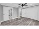 Bedroom featuring light gray walls, wood-look floors, and closet and bathroom access at 85 Ollie St, Atlanta, GA 30314