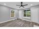 Bright bedroom showcasing natural light, new grey paint, vinyl plank flooring, and a ceiling fan at 85 Ollie St, Atlanta, GA 30314
