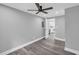 Spacious grey bedroom with a ceiling fan, vinyl plank floors, and a glimpse into the kitchen at 85 Ollie St, Atlanta, GA 30314