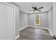Bedroom featuring a large closet, a ceiling fan, gray walls, and new floors for a modern look at 85 Ollie St, Atlanta, GA 30314