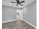 Bright and airy bedroom offering grey walls, new floors, a ceiling fan, and a view into the kitchen at 85 Ollie St, Atlanta, GA 30314