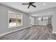 Open concept living room has grey walls, a wood floor, and a view to the kitchen at 85 Ollie St, Atlanta, GA 30314