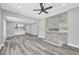 Open-concept living room with a modern fireplace, ceiling fan, and hardwood floors at 85 Ollie St, Atlanta, GA 30314