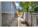 There is a narrow side yard with a new stairway leading to a fence at 85 Ollie St, Atlanta, GA 30314