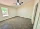 Bright, carpeted bedroom featuring a large window and ample natural light at 850 Greenhedge Dr, Stone Mountain, GA 30088