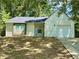 Charming one-story home with light siding, dark roof, attached garage, and a well-manicured front yard at 850 Greenhedge Dr, Stone Mountain, GA 30088