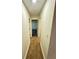 Neutral hallway with light wood floors and doors leading to bedrooms at 850 Greenhedge Dr, Stone Mountain, GA 30088