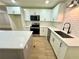 Modern kitchen featuring white cabinets, quartz countertops, stainless steel appliances and large island at 850 Greenhedge Dr, Stone Mountain, GA 30088