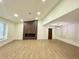 Bright, open living room with modern fireplace, wood floors, and vaulted ceilings at 850 Greenhedge Dr, Stone Mountain, GA 30088
