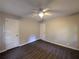 A medium sized bedroom with dark flooring, and two doors at 2904 Glenwood Se Ave, Atlanta, GA 30317