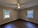 A medium sized bedroom with dark flooring, and two windows at 2904 Glenwood Se Ave, Atlanta, GA 30317
