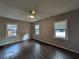 A medium sized bedroom with dark flooring, and three windows at 2904 Glenwood Se Ave, Atlanta, GA 30317