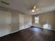 A medium sized bedroom with dark flooring, window, and two doors at 2904 Glenwood Se Ave, Atlanta, GA 30317