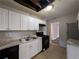Kitchen with white cabinets, tile floors, and modern appliances at 2904 Glenwood Se Ave, Atlanta, GA 30317