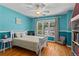 Well-lit bedroom with ceiling fan and hardwood floors at 4961 Thornwood Nw Trce, Acworth, GA 30102