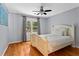 Bedroom with hardwood floors, ceiling fan, and bright window at 4961 Thornwood Nw Trce, Acworth, GA 30102