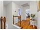 Hallway with hardwood floors leading to bedrooms and bathrooms, offering seamless flow at 4961 Thornwood Nw Trce, Acworth, GA 30102