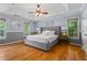 Serene main bedroom with a tray ceiling, hardwood floors, and ample natural light at 4961 Thornwood Nw Trce, Acworth, GA 30102