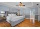 Serene main bedroom with a tray ceiling, hardwood floors, and ample natural light at 4961 Thornwood Nw Trce, Acworth, GA 30102