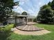 View of the backyard with a wood deck, trees, and blue sky at 1855 Tribble Ridge Dr, Lawrenceville, GA 30045