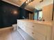 This bathroom features a double sink vanity, a commode, and a large mirror at 1855 Tribble Ridge Dr, Lawrenceville, GA 30045