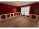 Empty bedroom features wainscoting on walls, neutral carpet, and a window that allows for plenty of natural light at 1855 Tribble Ridge Dr, Lawrenceville, GA 30045