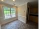 Sunny breakfast nook with large windows, tile flooring, and views of outdoor living at 1855 Tribble Ridge Dr, Lawrenceville, GA 30045